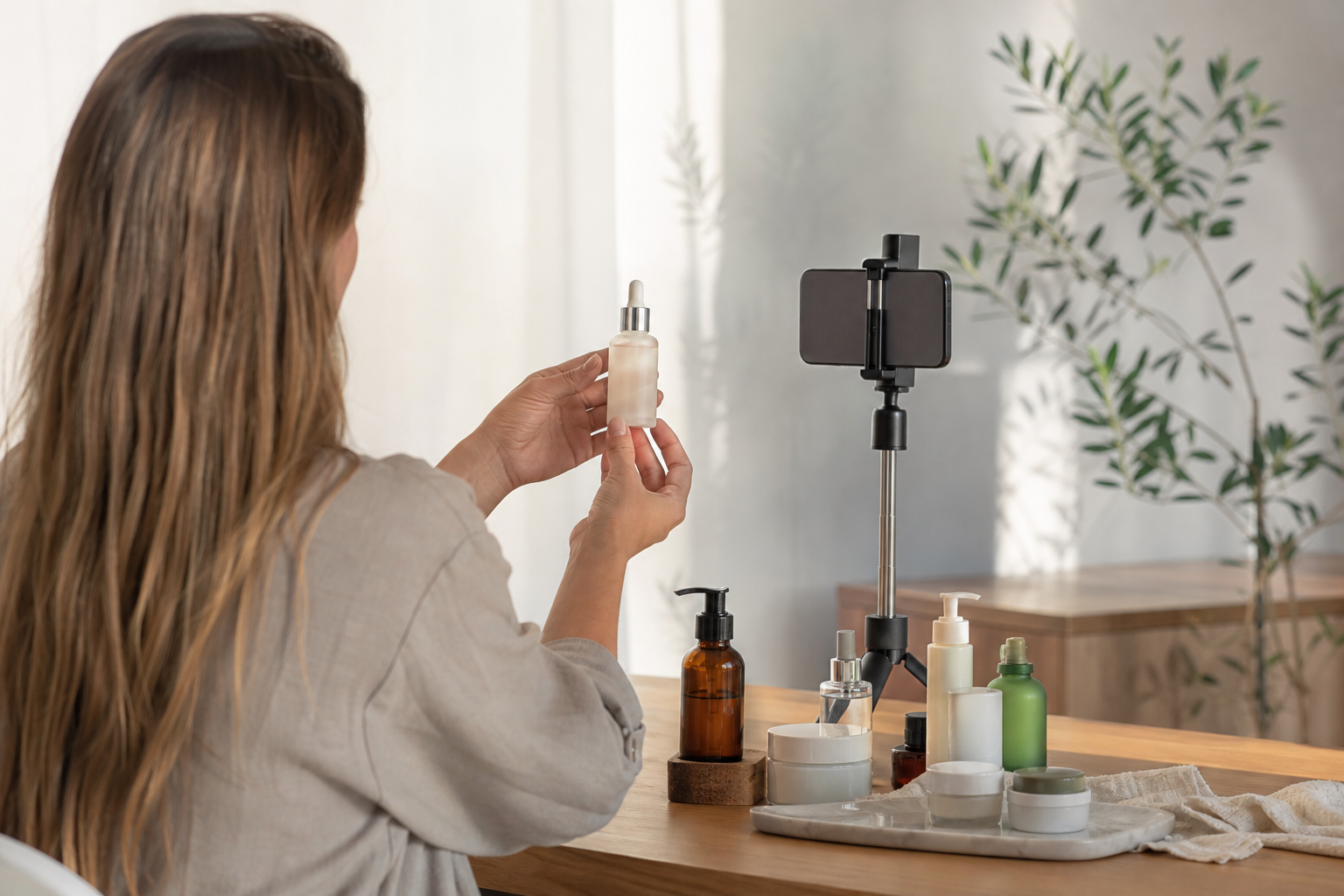 UGC creator filming a portfolio video of a product with her phone on a tripod